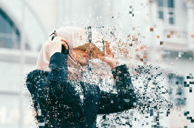 Man photographing with mobile phone in water