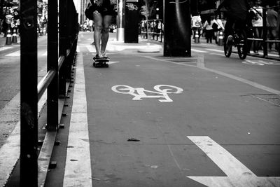 Low section of people walking on sidewalk