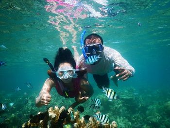 Couple snorkeling in sea