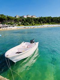 Boats moored on sea against sky