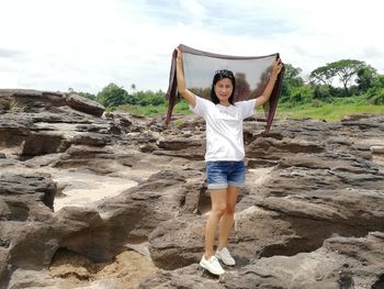 Full length of woman standing on rock