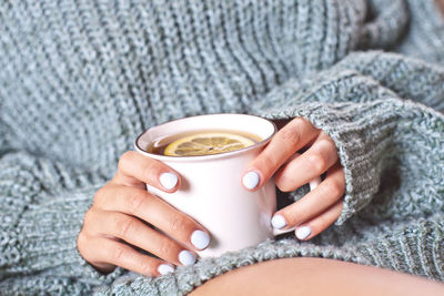 Midsection of woman holding coffee