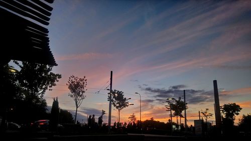 Low angle view of silhouette trees against sky during sunset