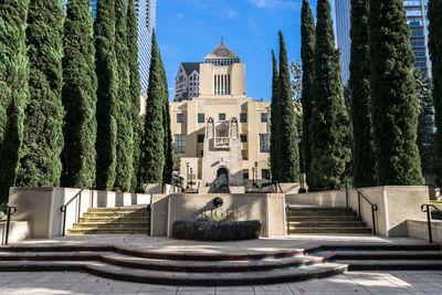 Exterior of building by trees against sky