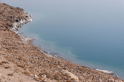 High angle view of rocks on beach against sky