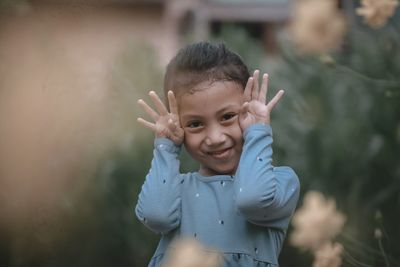 Portrait of smiling girl standing outdoors