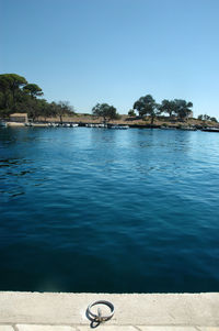 Scenic view of sea against clear blue sky