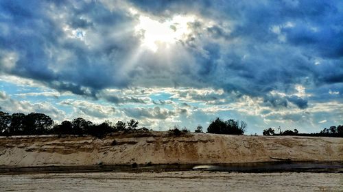 Panoramic view of landscape against storm clouds