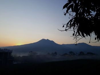 Scenic view of silhouette mountains against sky at sunset