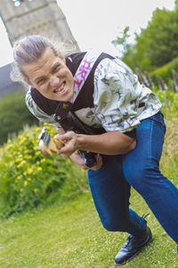 Woman smiling while sitting on plant