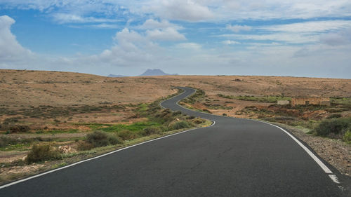 Road amidst landscape against sky