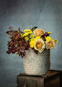 Close-up of yellow flower vase on table