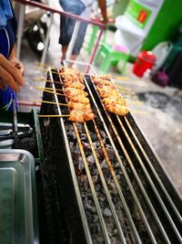 Close-up of preparing food on barbecue grill