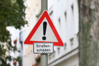 Close-up of warning sign on pole