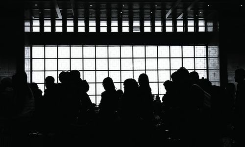 Silhouette of people in room