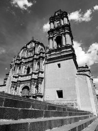 Low angle view of bell tower against cloudy sky