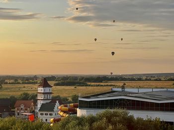 Scenic view of buildings against sky during sunset