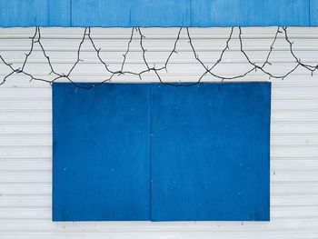 Blue  wooden panel on white metallic wall.  decorate design concept