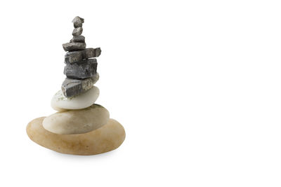 Close-up of stone stack against white background