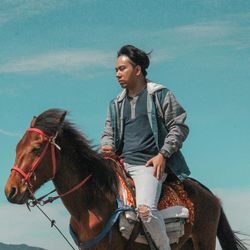 Young man riding horse