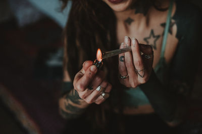 Close-up of woman hand holding cigarette