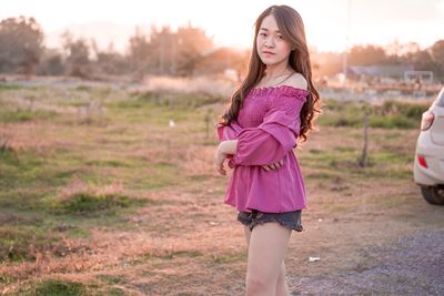 Portrait of woman standing on field