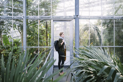 Man standing in greenhouse