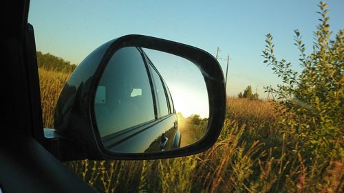 Reflection of sky in side-view mirror