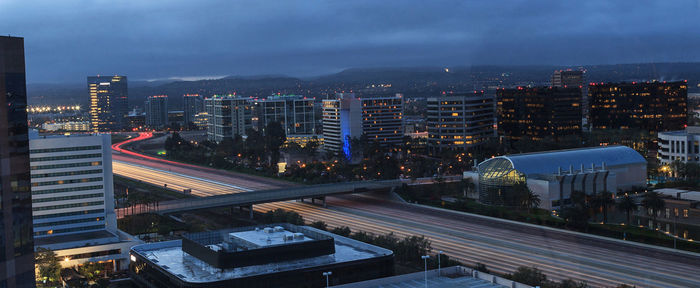 Light trails on road in city at dusk