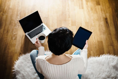 Beautiful woman holds in her hand a black tablet