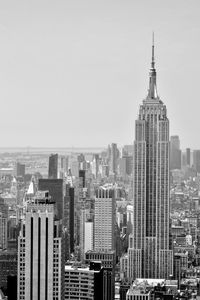 Modern buildings in city against clear sky