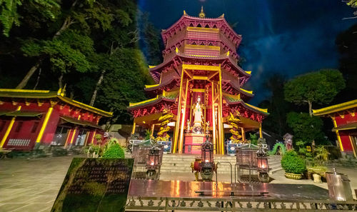 View of illuminated temple building against sky