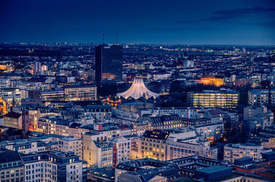 High angle view of illuminated cityscape against sky at night