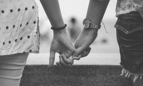 Close-up of couple holding hands