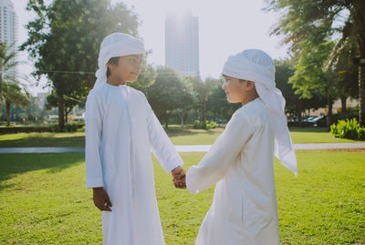 Side view of couple standing on field