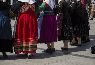 Rear view of people walking on street