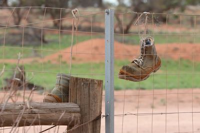 Hanging your boots up on a fence