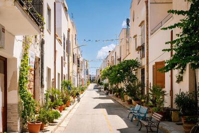 People walking on street amidst buildings in city