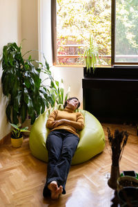 Full length woman resting at home