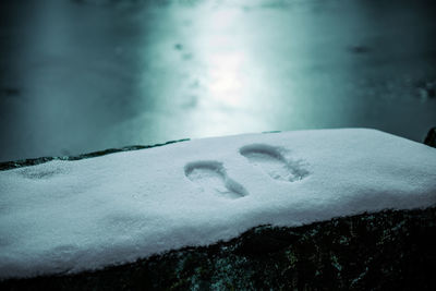 Scenic view of snow covered mountains against cloudy sky