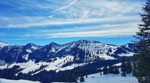 Scenic view of snowcapped mountains against sky