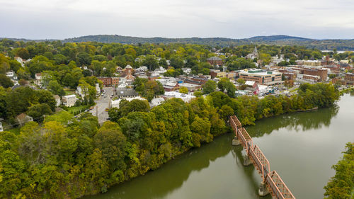 High angle view of river amidst buildings against sky