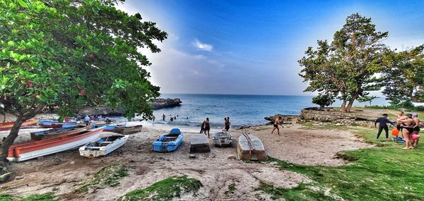 People on beach against sky