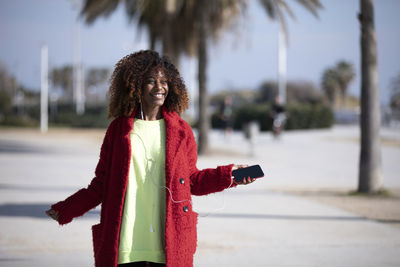 Rear view of woman holding umbrella