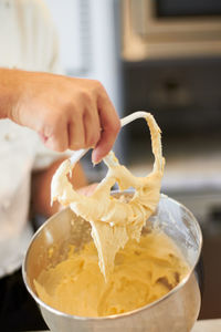Cropped hand of person preparing food