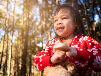 Portrait of cute baby girl in forest