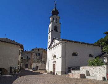 Low angle view of buildings against clear blue sky