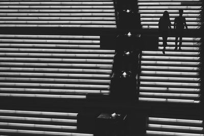 Shadow of people walking on tiled floor