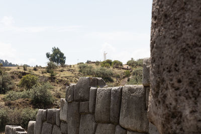 Panoramic view of stone wall against sky