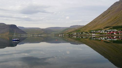 Scenic view of lake and mountains against sky